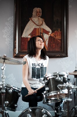 #3   Kathleen Hanna playing the drums. Photo courtesy of Allison Michael Orenstein